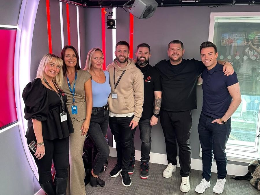 Greg and a group at the Heart Radio studio